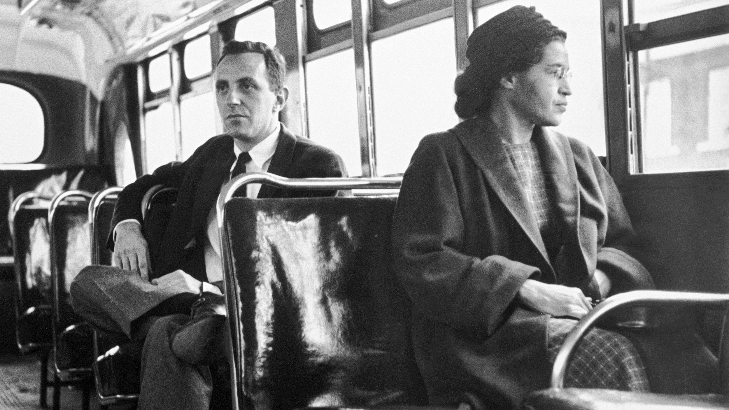 Rosa Parks sits in the front of a bus in Montgomery, Alabama, after the Supreme Court ruled segregation illegal on the city bus system on December 21st, 1956. Parks was arrested on December 1, 1955 for refusing to give up her seat in the front of a bus in Montgomery set off a successful boycott of the city busses. Man sitting behind Parks is Nicholas C. Chriss, a reporter for United Press International out of Atlanta.